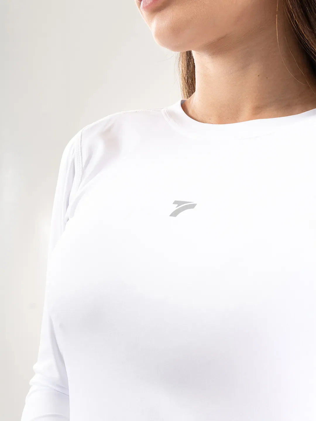 Buzo compresión mujer blanco TENFIT vista lateral — ajuste ceñido